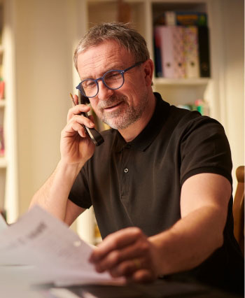 UtilityFix  Customer  happily looking at the Electric Bill after comparison 