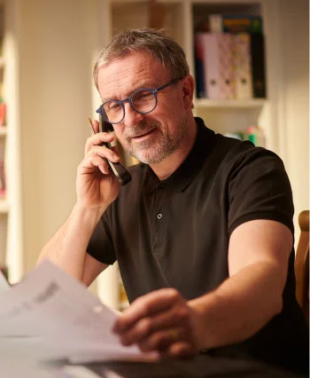 UtilityFix  Customer  happily looking at the Electric Bill after comparison 